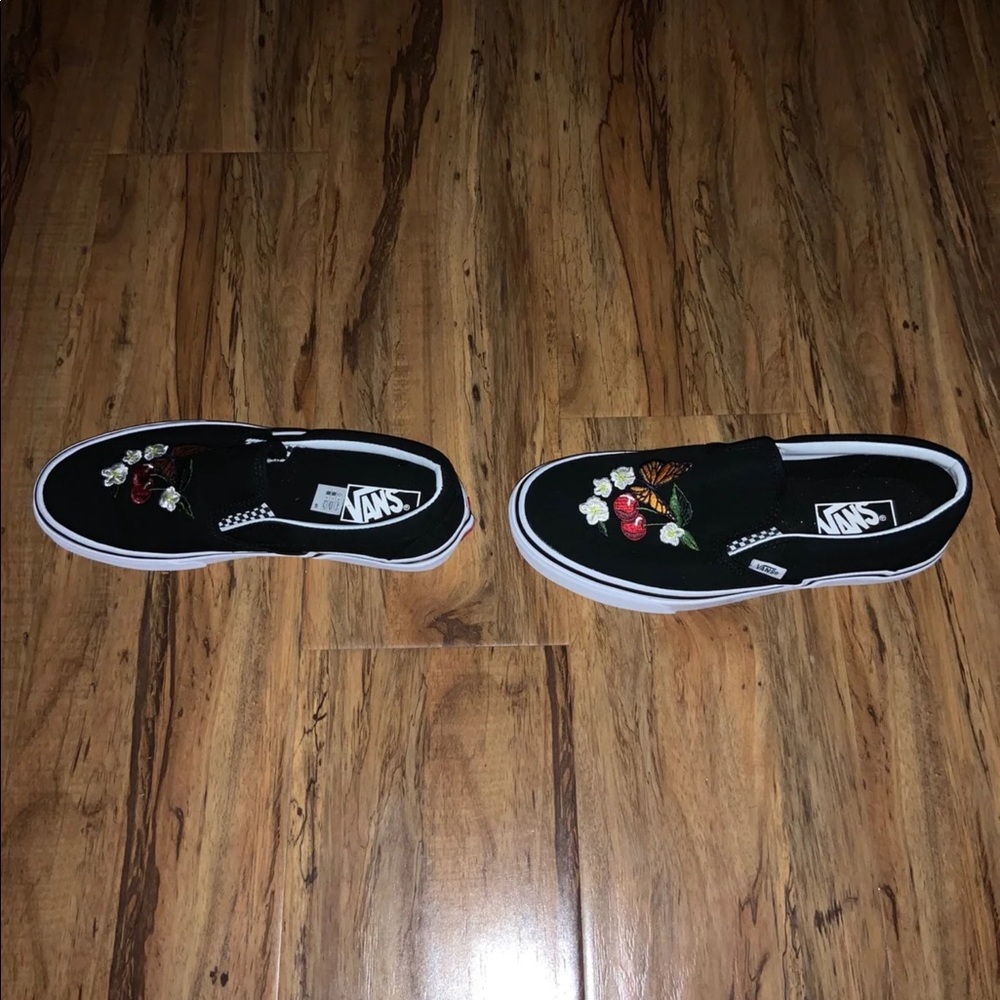 Black embroidered checkerboard vans